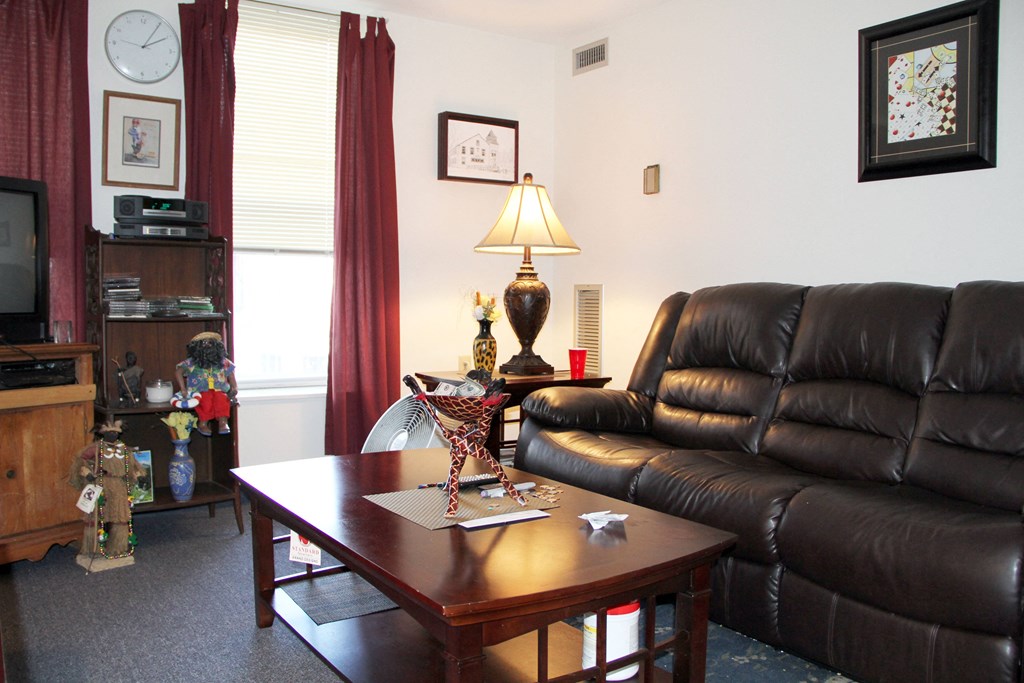 a living room with a leather couch and a coffee table