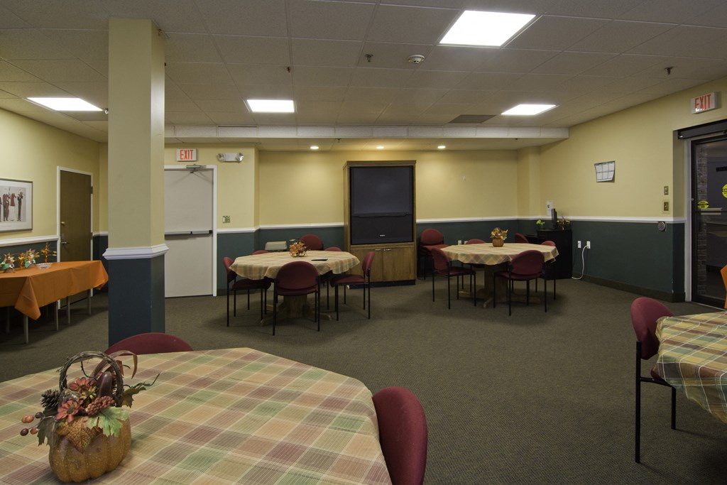 a dining room with tables and chairs in a hall