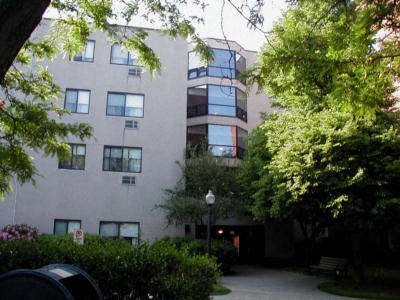 an apartment building with trees in front of it