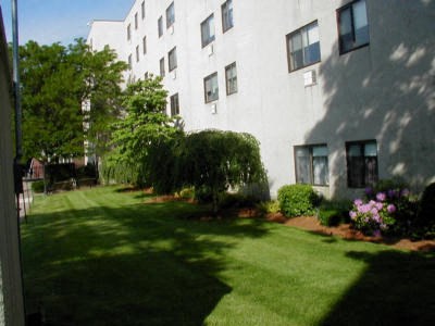 a large white building with a yard in front of it