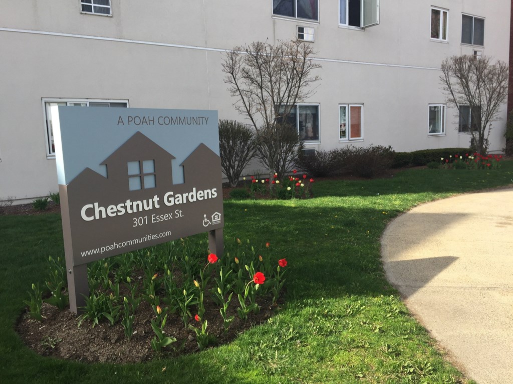 a sign for chesnut gardens in front of a building
