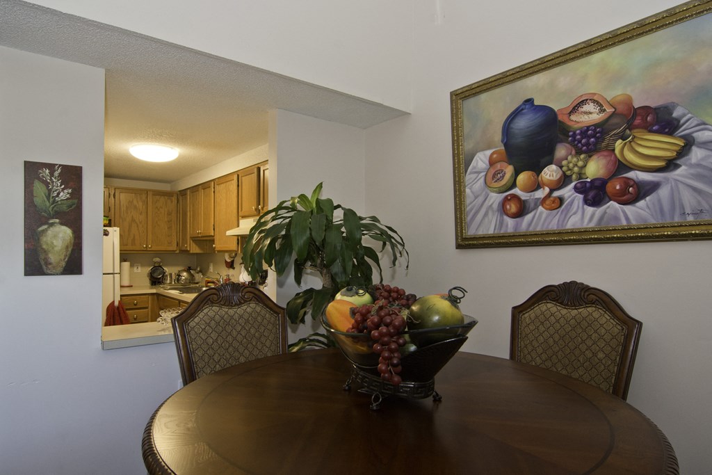 a dining room table with a bowl of fruit on it