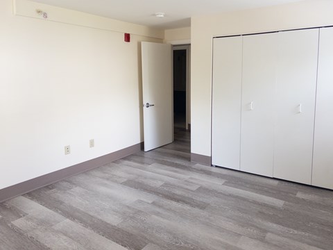 A room with a white door and a white cabinet.