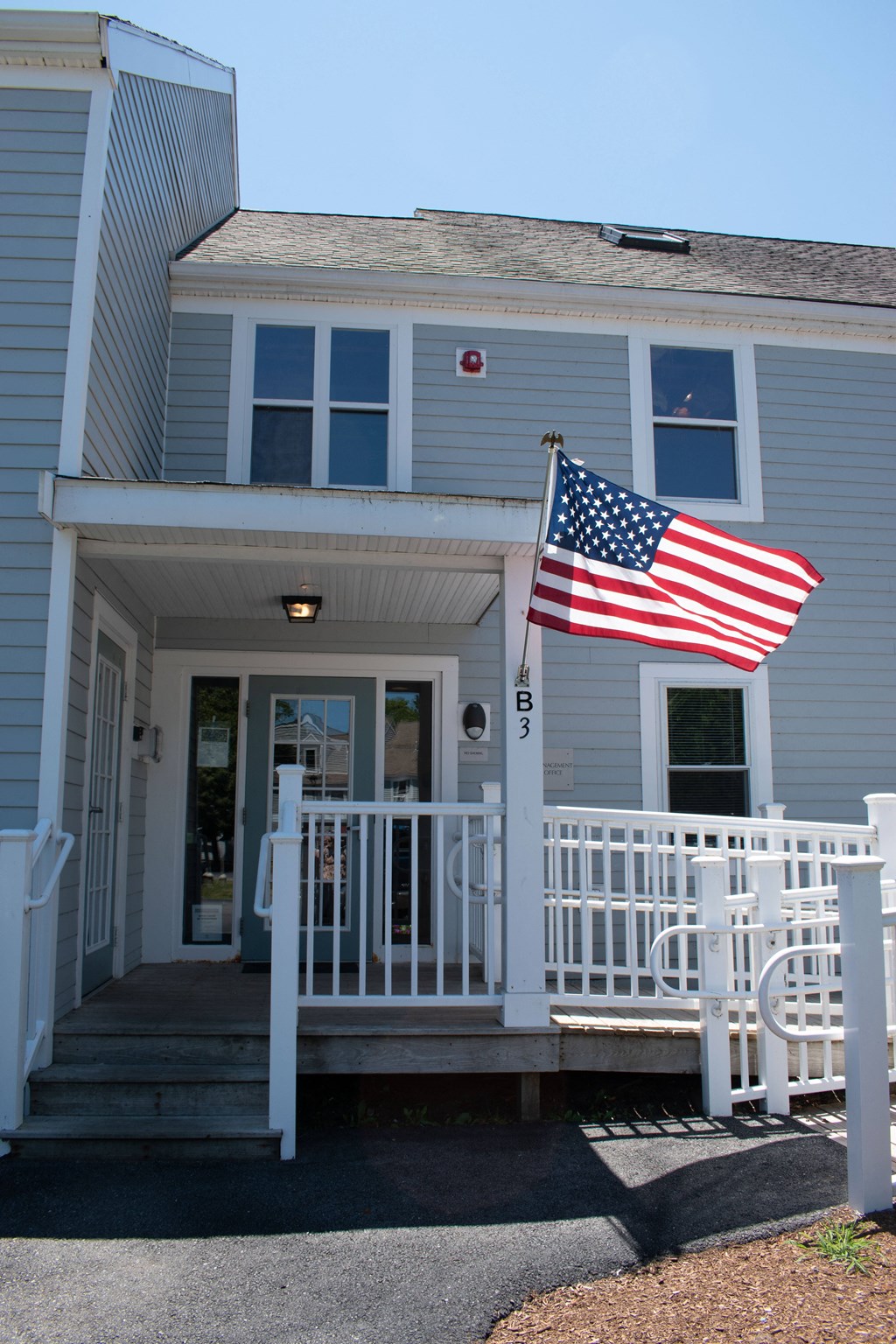 an flag flies in front of a house