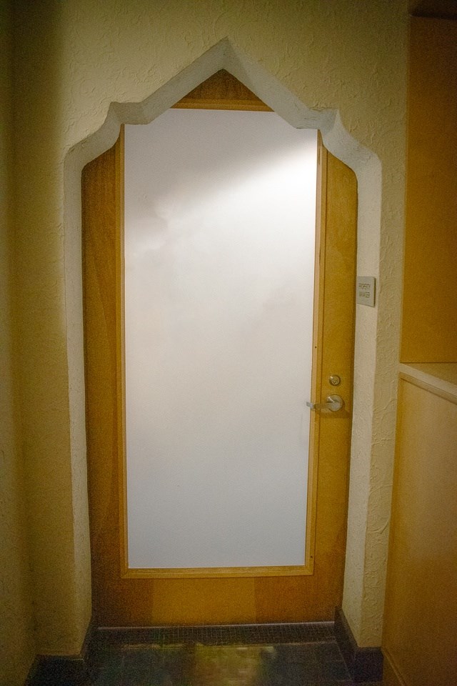 a door in a room with a white wall
