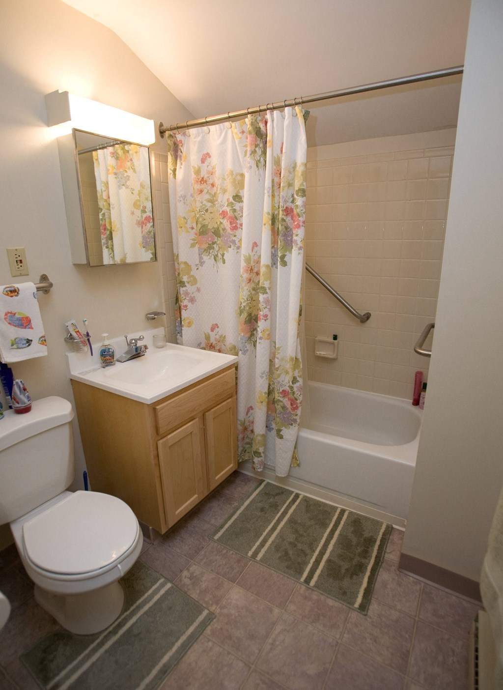 a bathroom with a toilet sink and tub and a shower curtain