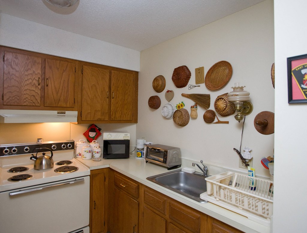 a kitchen with a stove top oven and a sink