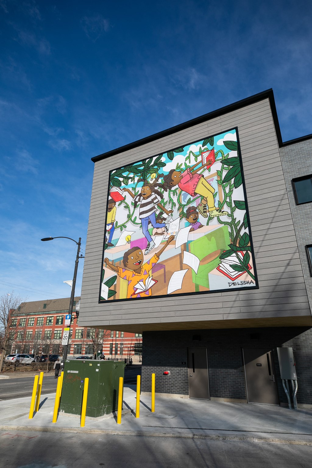 A large mural on a building's side depicts a group of people.