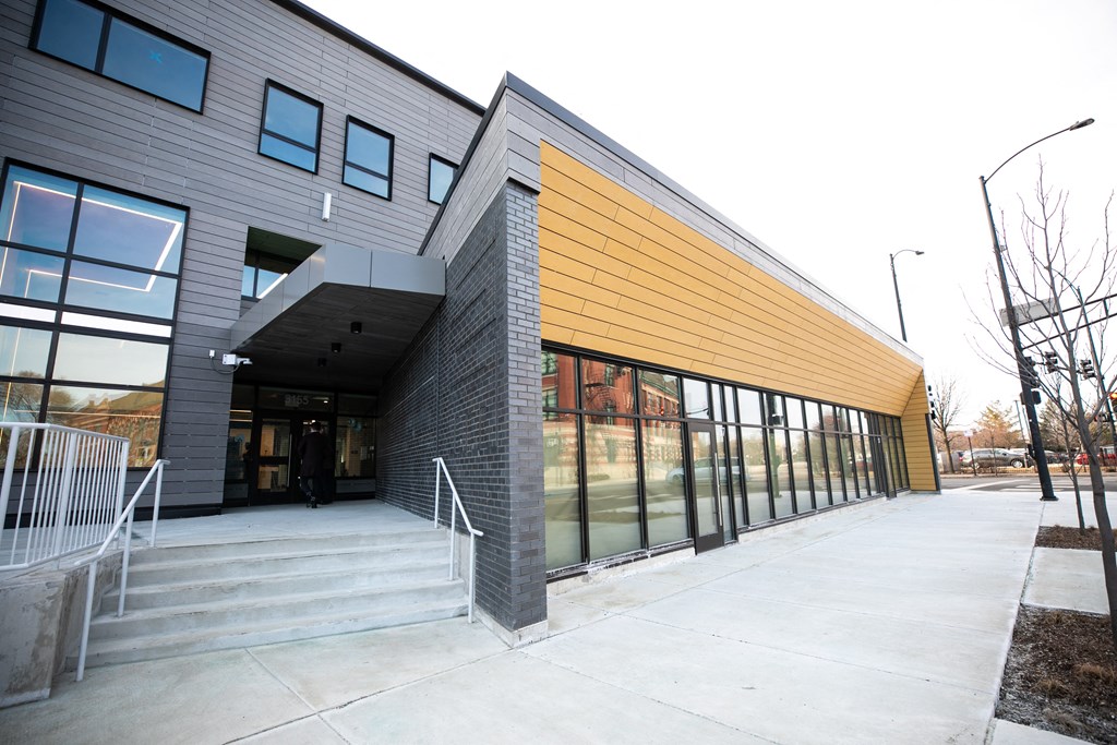 A modern building with a combination of grey and yellow panels.