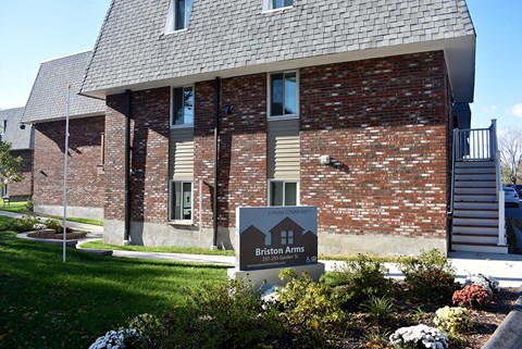 A small house with a sign in front that says Briston Arms.
