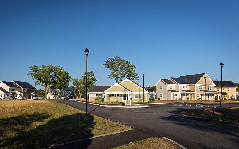 a row of houses on a street with a road