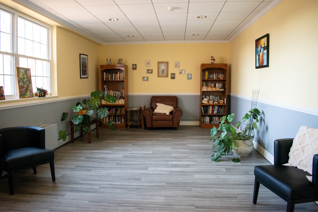 the waiting room of a physicians office with chairs and plants
