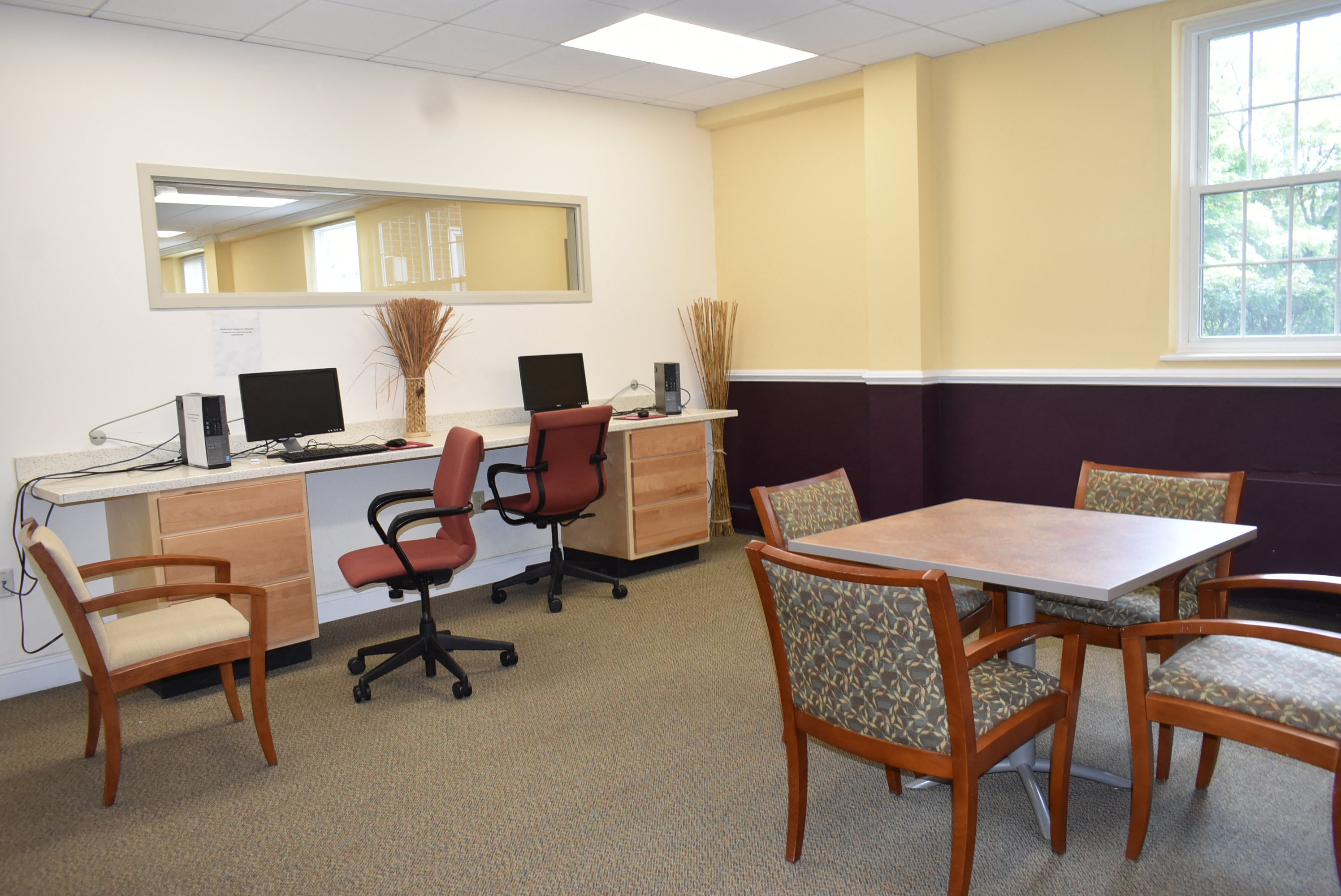a conference room with desks and chairs and a table