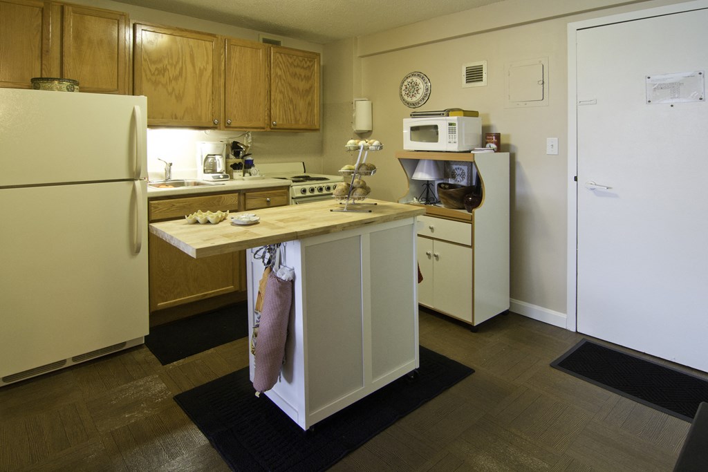 a kitchen with a counter top and a refrigerator