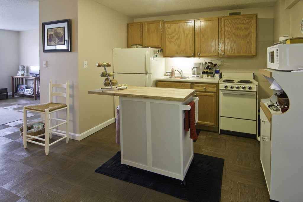 a kitchen with an island and a refrigerator and a stove