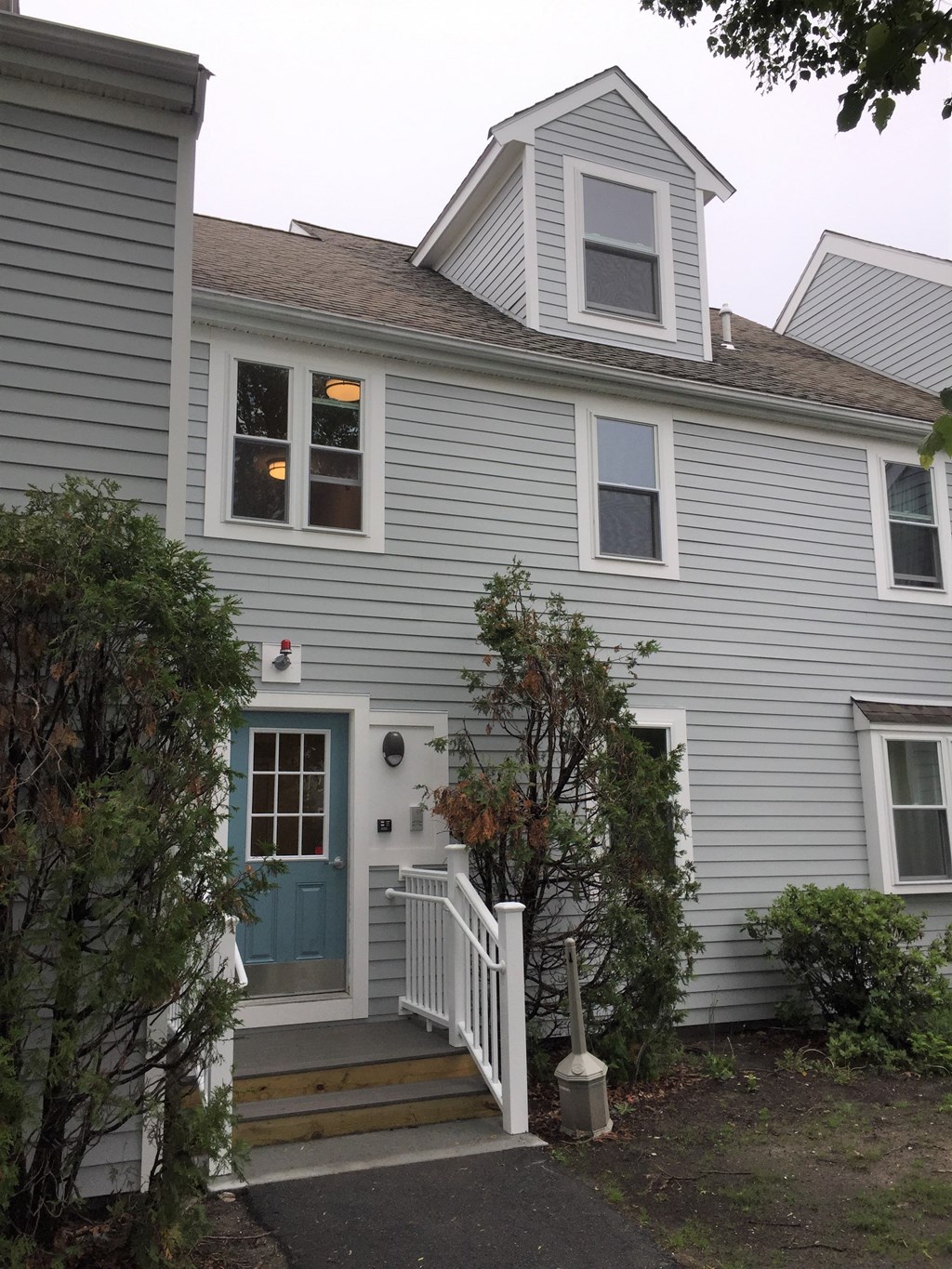 the front of the house with a blue door