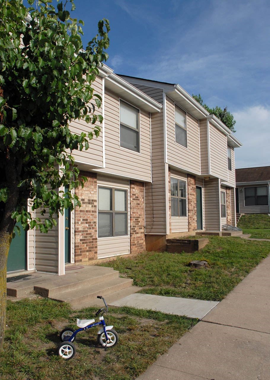 a childs bike parked in front of a house