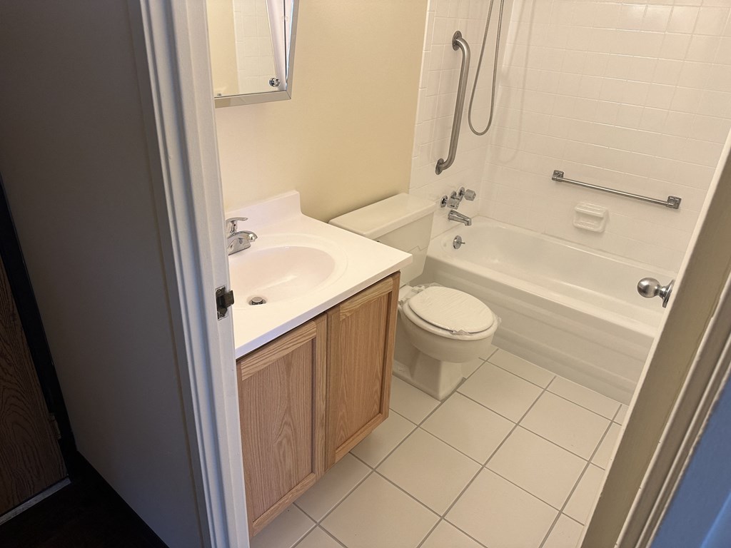 a small bathroom with a sink toilet and bath tub