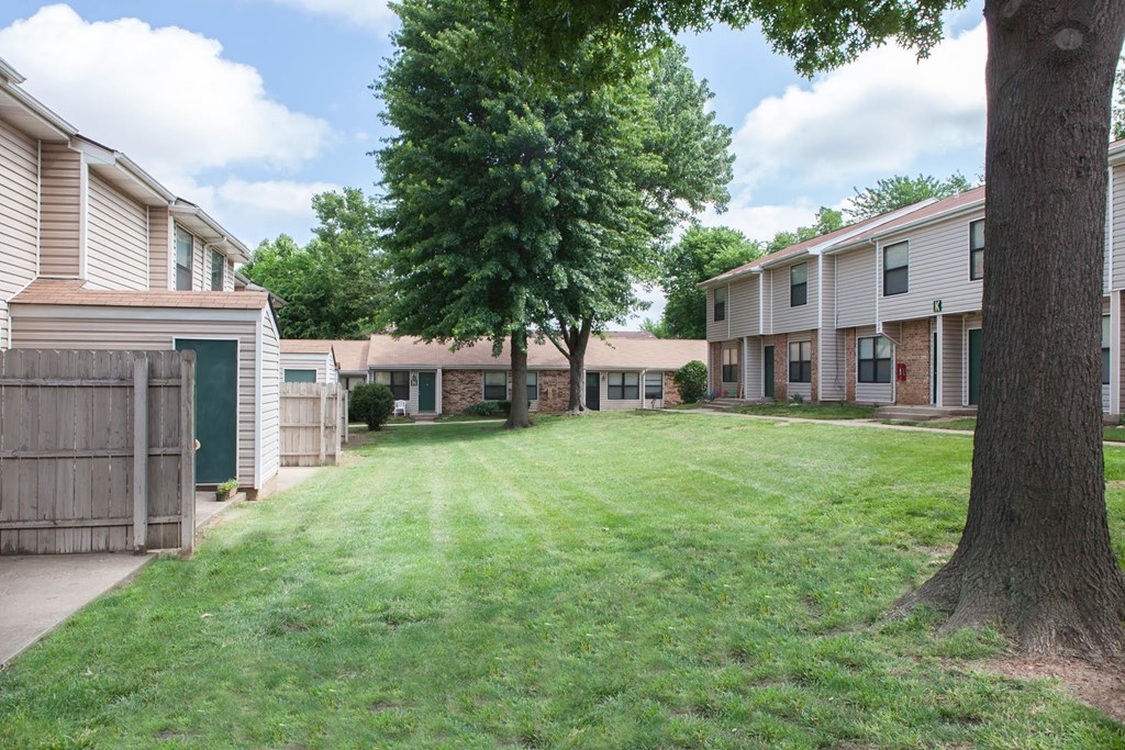 our apartments are located in a quiet neighborhood with green grass and trees