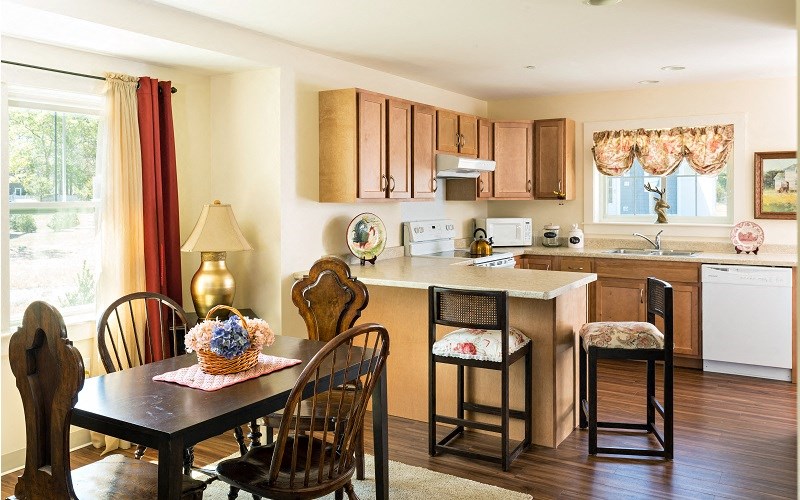 a kitchen and dining area with a table and chairs