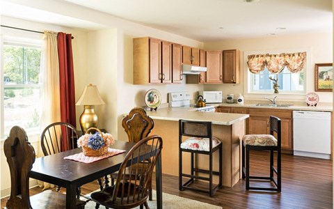 a kitchen and dining area with a table and chairs