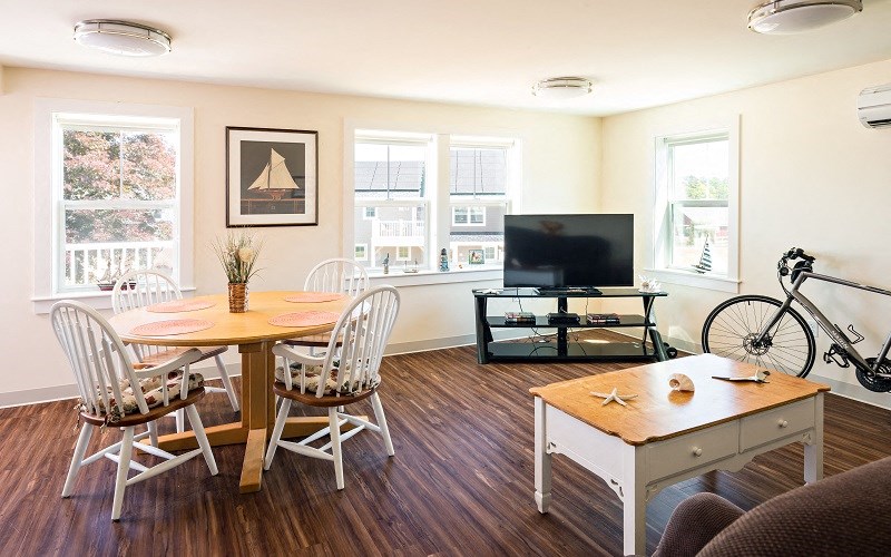 a living room with a table and chairs and a television
