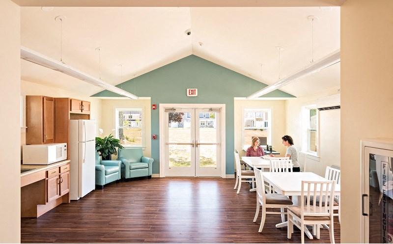 two people sitting at a table in a dining room