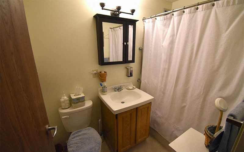 A bathroom with a toilet, sink, and shower curtain.
