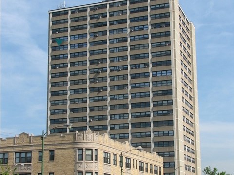 A tall building with a green arrow on the side.