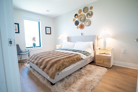 a bedroom with a bed and several plates on the wall