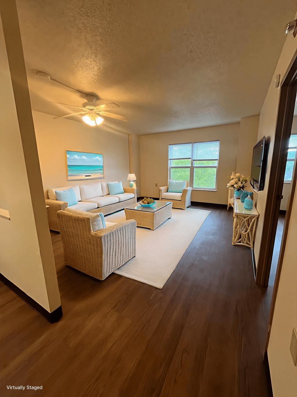A living room with a couch, a chair, and a rug.
