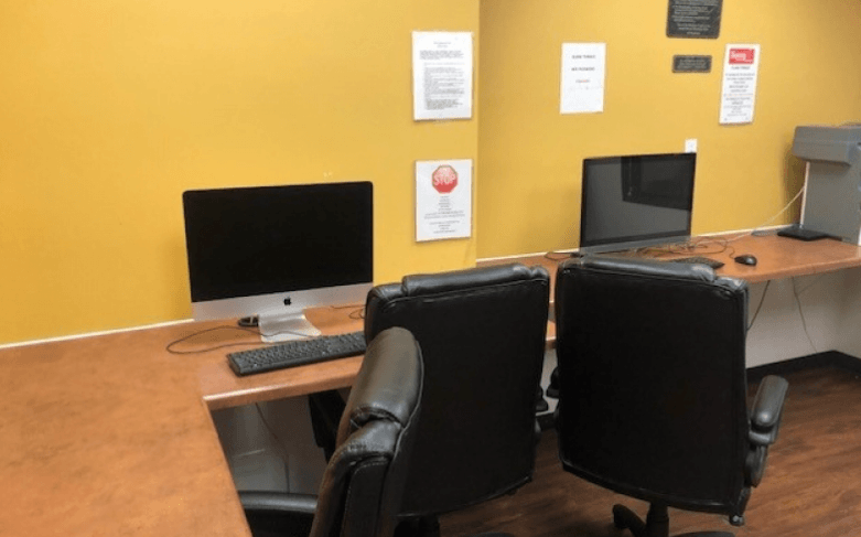 a desk with two computer monitors on it