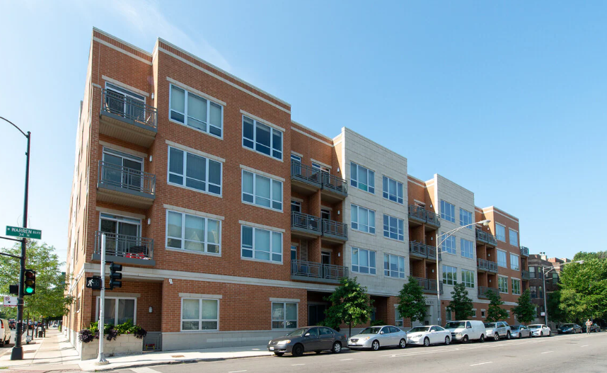 a building on a city street with cars parked in front of it