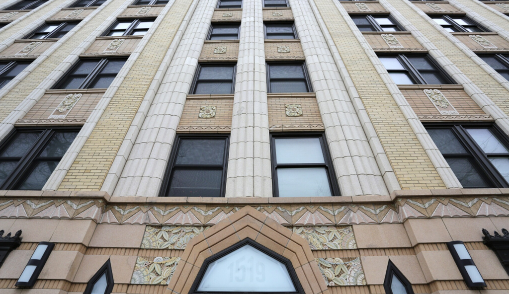 the front of a tall building with many windows