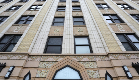the front of a tall building with many windows