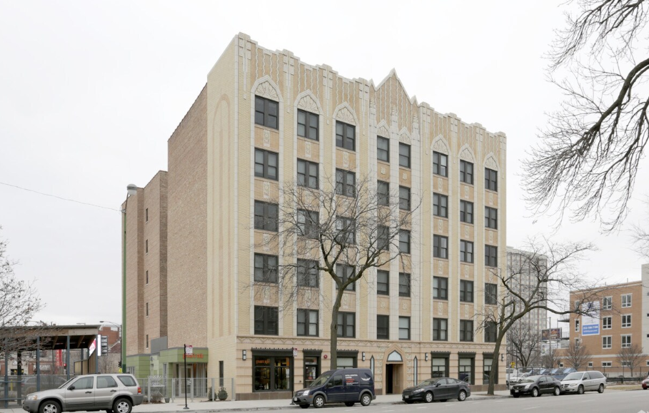 a building with cars parked in front of it on a city street