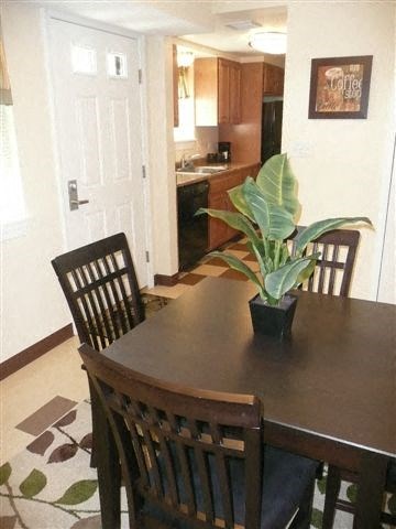 A dining room with a table and chairs.