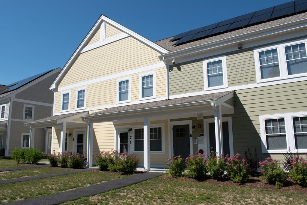 a row of houses with solar panels on the roof