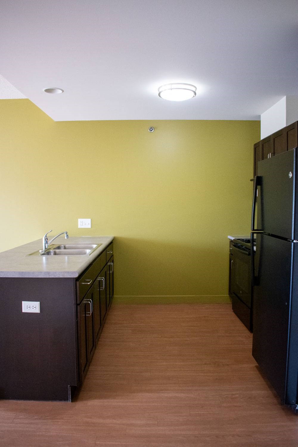 a kitchen with a sink and a refrigerator