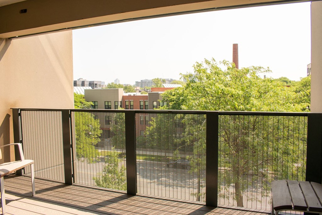 a balcony with a bench and a view of the city