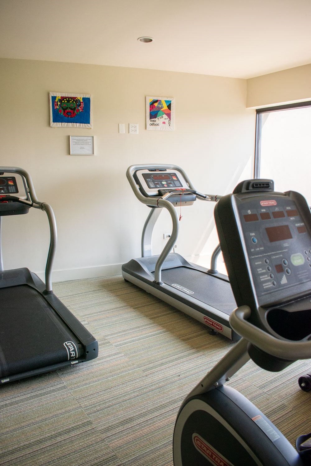 a room with two treadmills and two exercise bikes