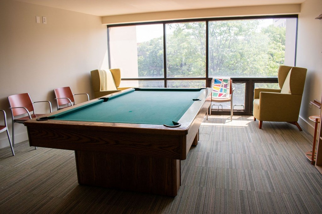 a large room with a pool table and a balcony