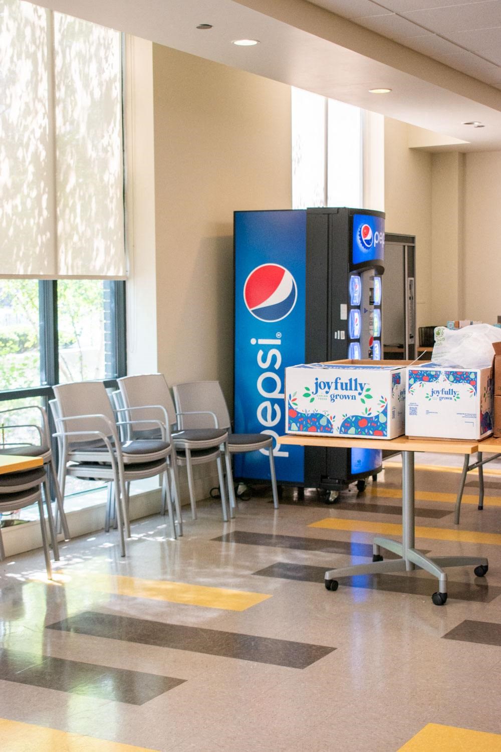 a vending machine in a room with chairs and tables