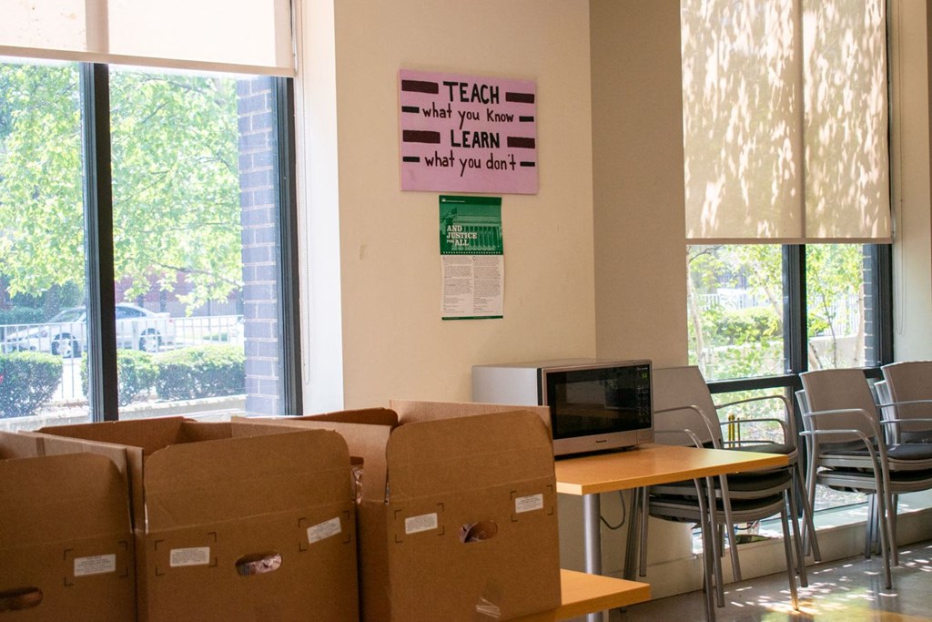 a room with cardboard boxes and a computer on a table