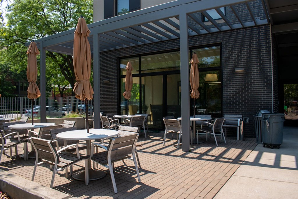 a patio with tables and chairs