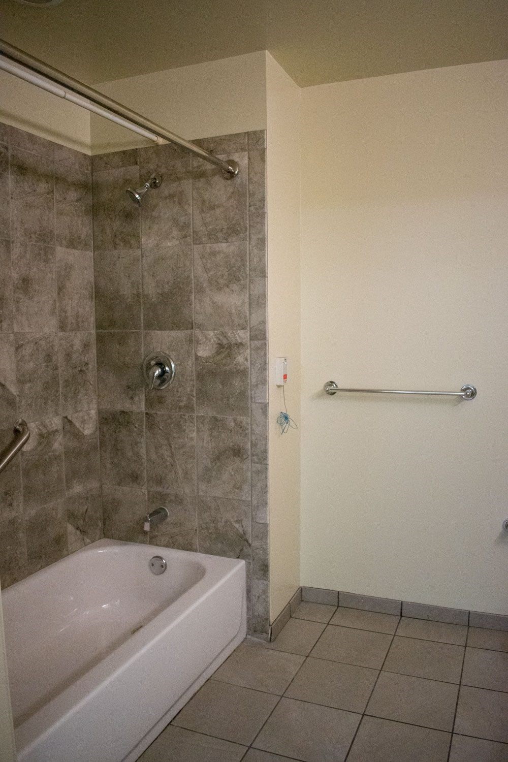 a bathtub and shower in a hotel room
