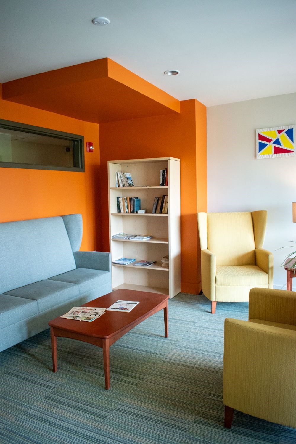 a living room with orange and white walls