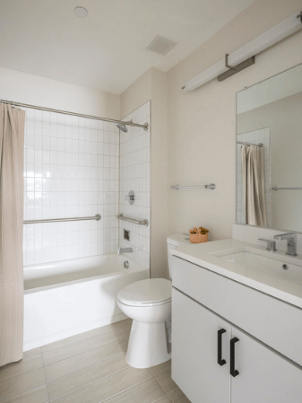 A white bathroom with a toilet, sink, and bathtub.