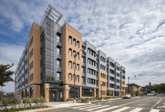 A modern building with a glass facade and a brown exterior.