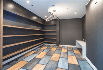 A room with a wooden floor and a white bench.